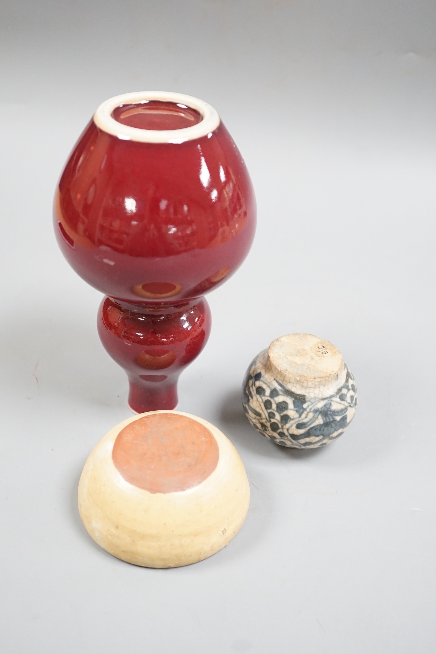 A Chinese sang de boeuf double gourd vase, a Swatow blue and white jarlet and a small cup, tallest 17cm